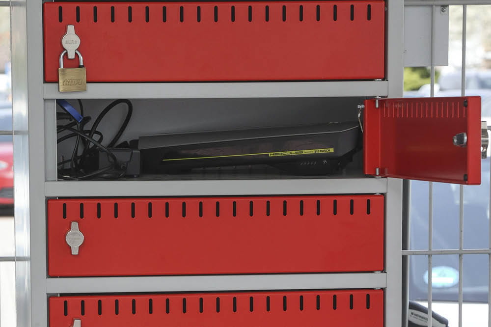 Locker with an open door and a battery inside.