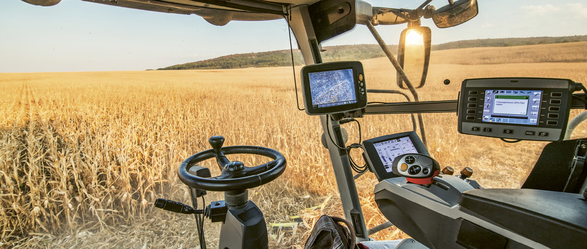 View from a combine harvester with screens onto a wheat field. Copyright: iStock/ArtistGNDphotography