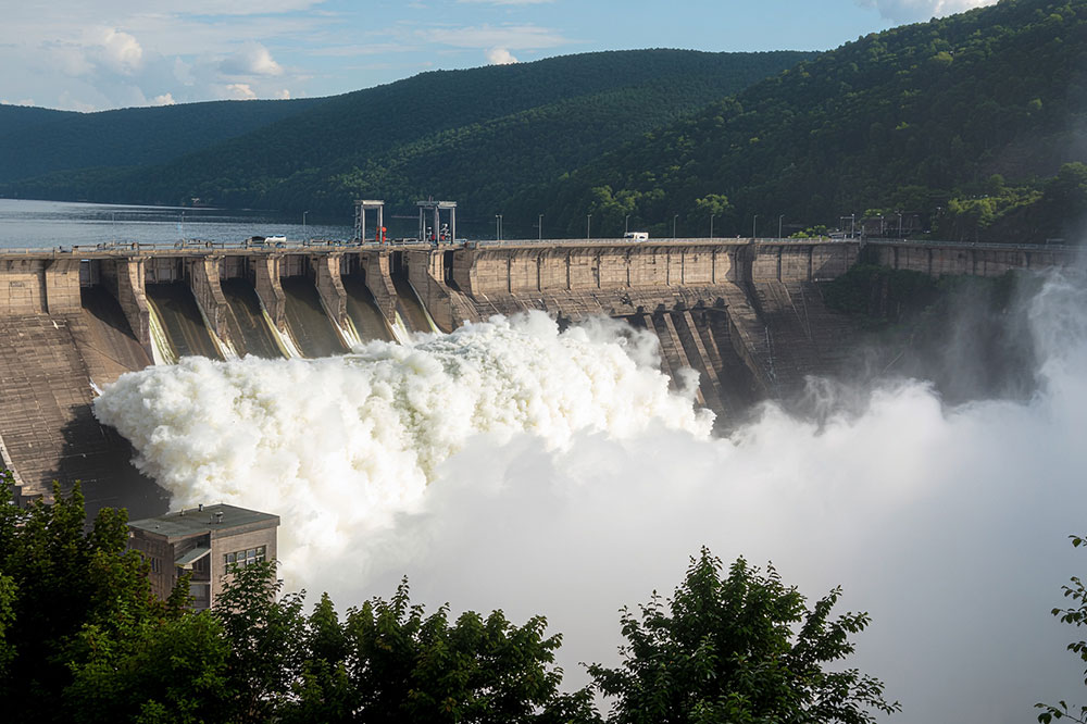 A shot of a large reservoir filled with foaming water at a hydropower plant