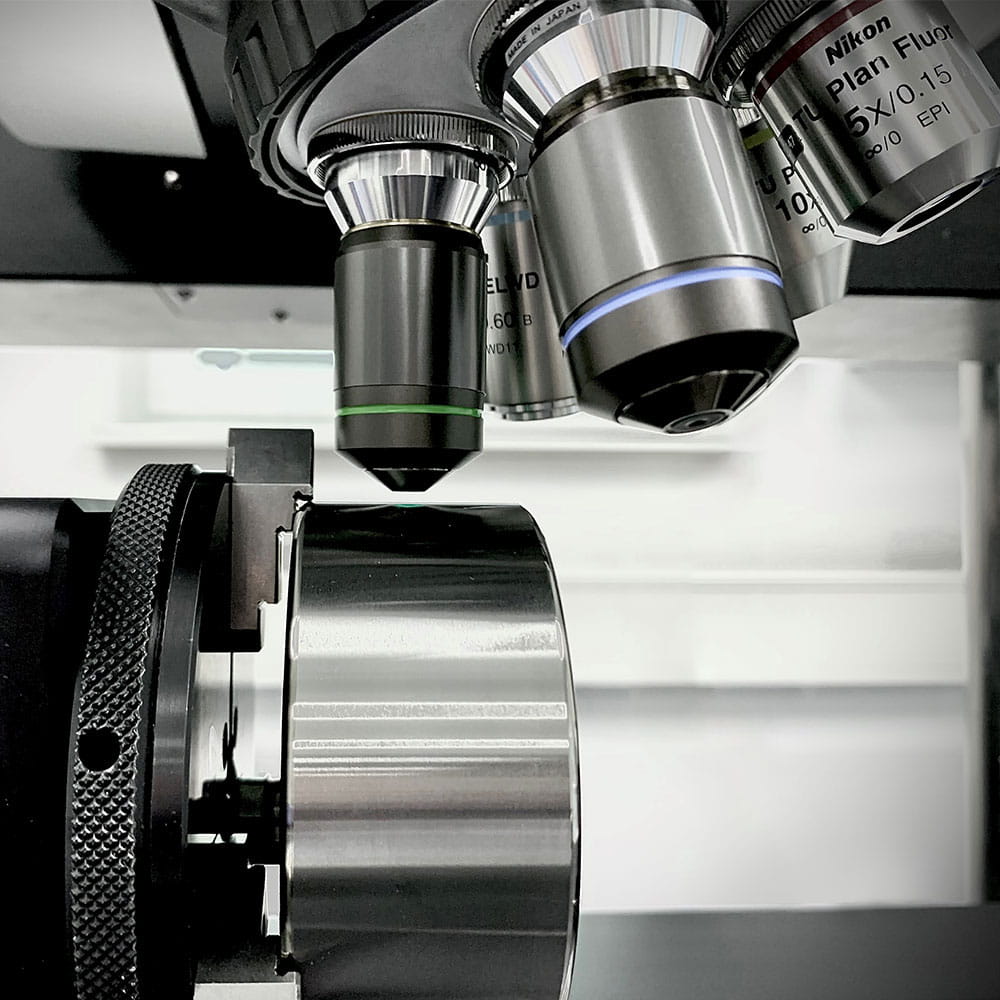 microscope pointed at metallic shaft