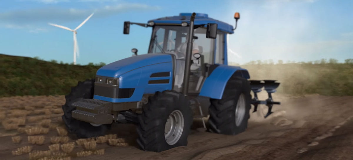Traktor auf dem Feld und im Hintergrund sieht man ein Windkraftrad